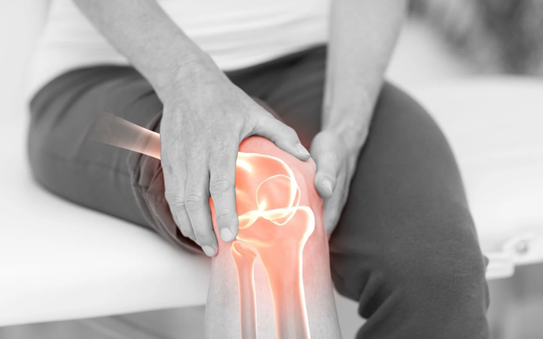 A patient holding a painful knee during an examination at Halcyon